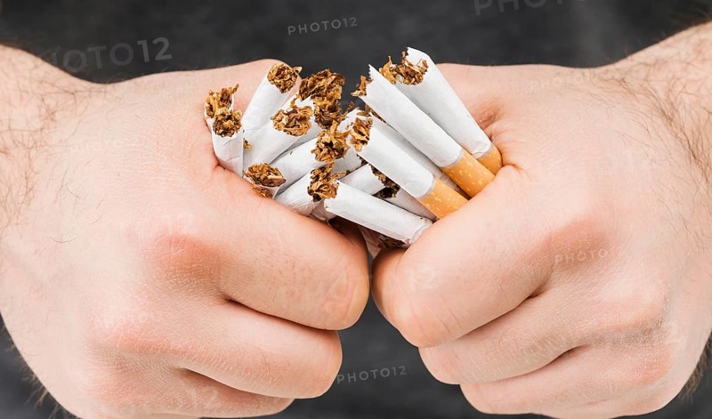 Close up hands breaking bundle cigarettes