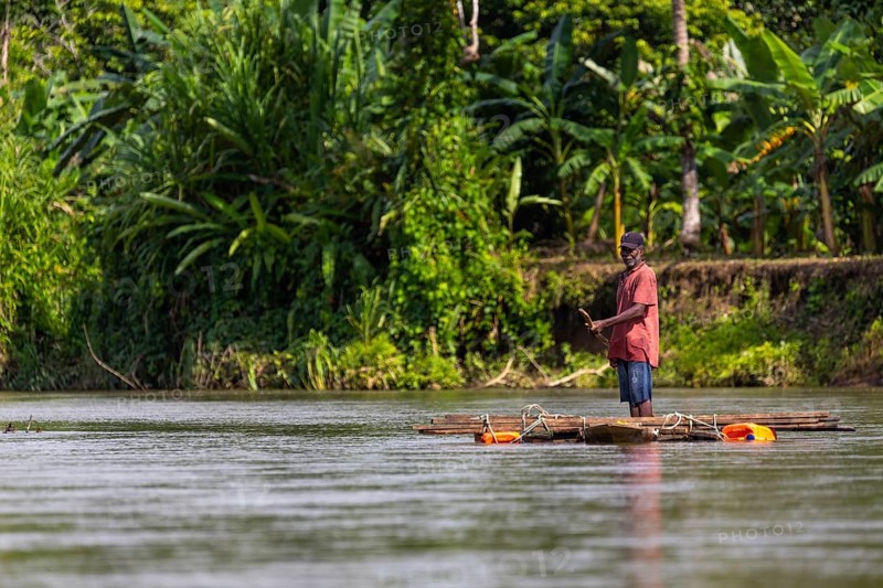 Man on a wooden raft