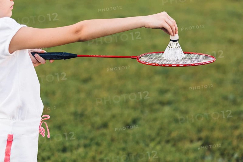 Close up girl playing badminton