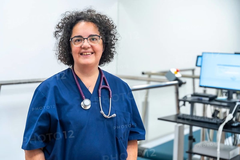 Portrait of a smiling mature cardiologist standing proud with arms crossed in the hospital