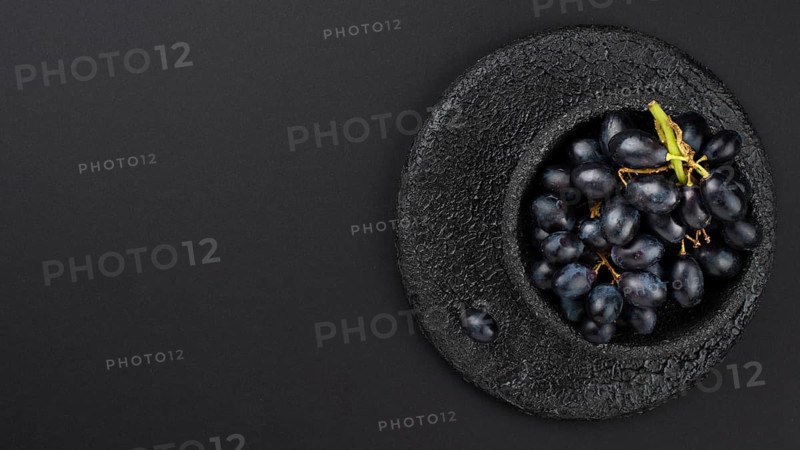 Black grapes bowl with copy space