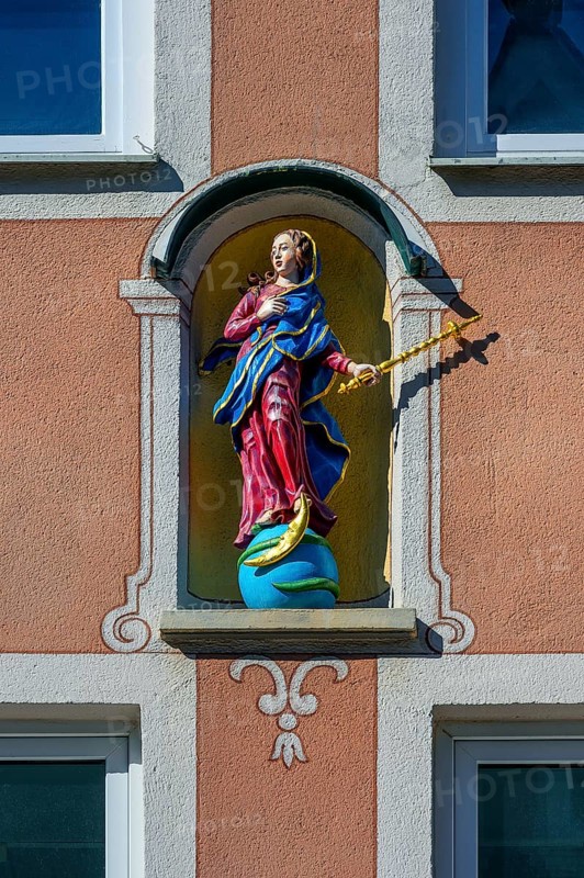 Facade with Madonna figure on globe with moon and snake