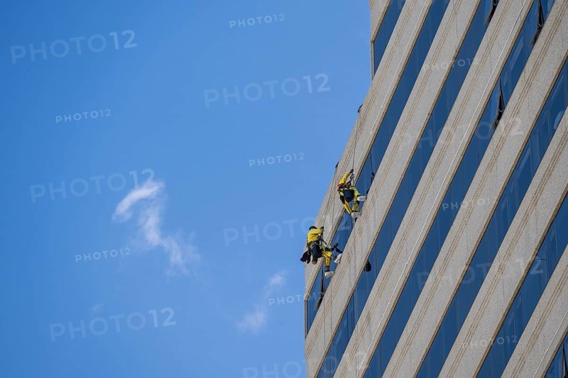 Window cleaner on a high-rise facade