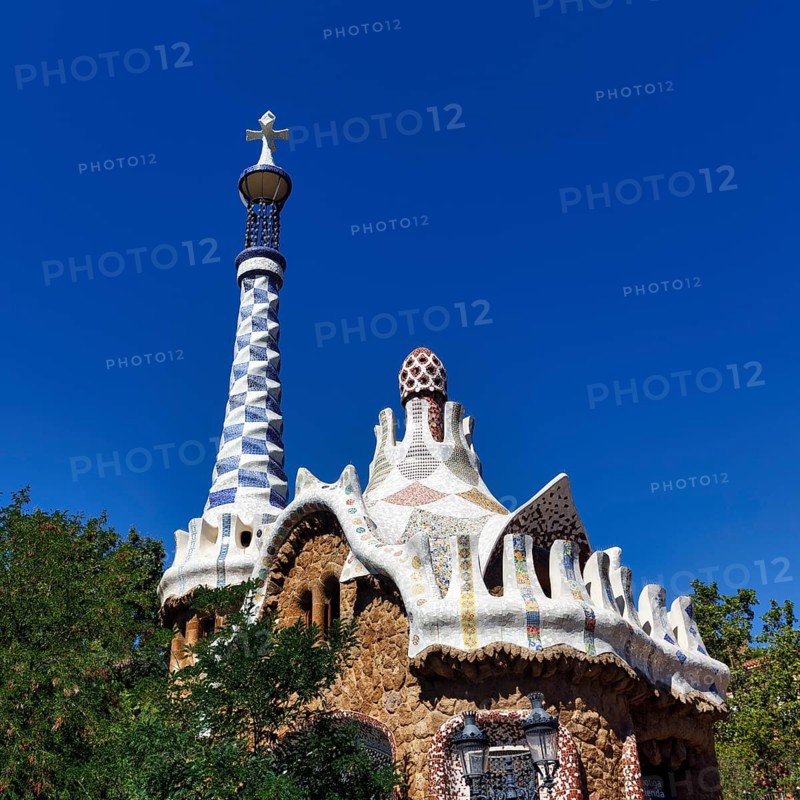 Mosaics decorate the tower and roof of a house