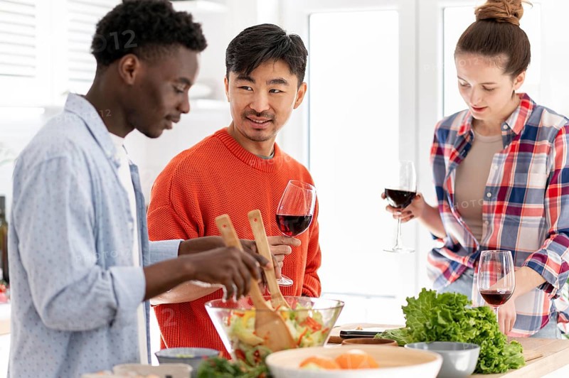 Medium shot friends making food