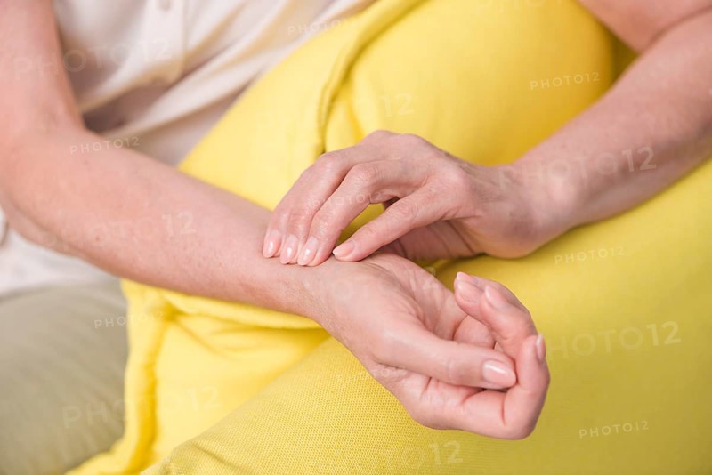 Close up woman s hand checking wrist pulse