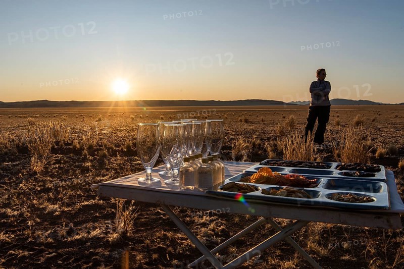 Table with glasses and snacks for the sundowner