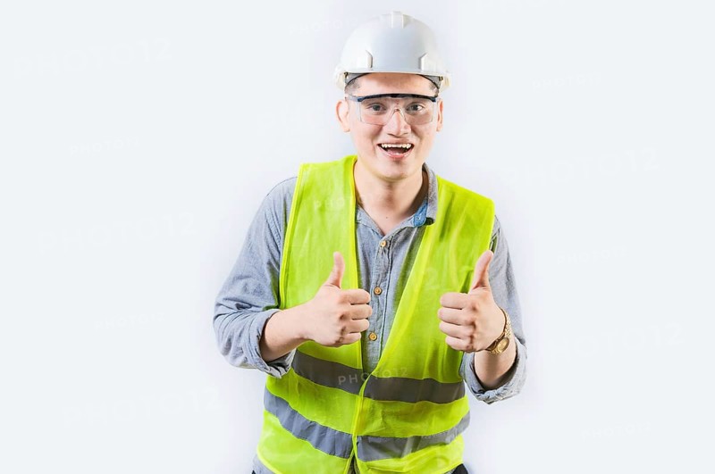 Positive young engineer showing ok gesture isolated. Handsome engineer gesturing ok approved isolated