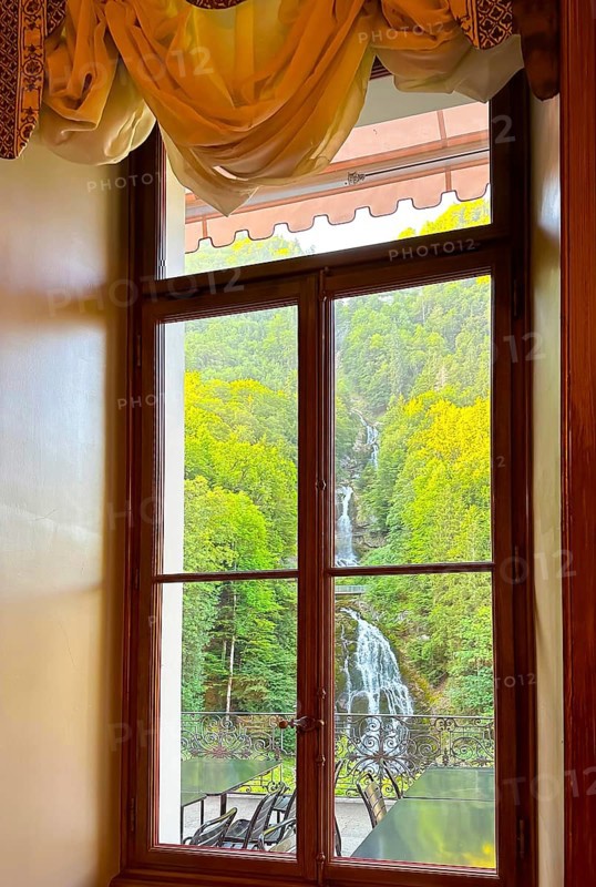 Grandhotel Giessbach with Window View over Giessbach waterfall in a Sunny Summer Day in Brienz