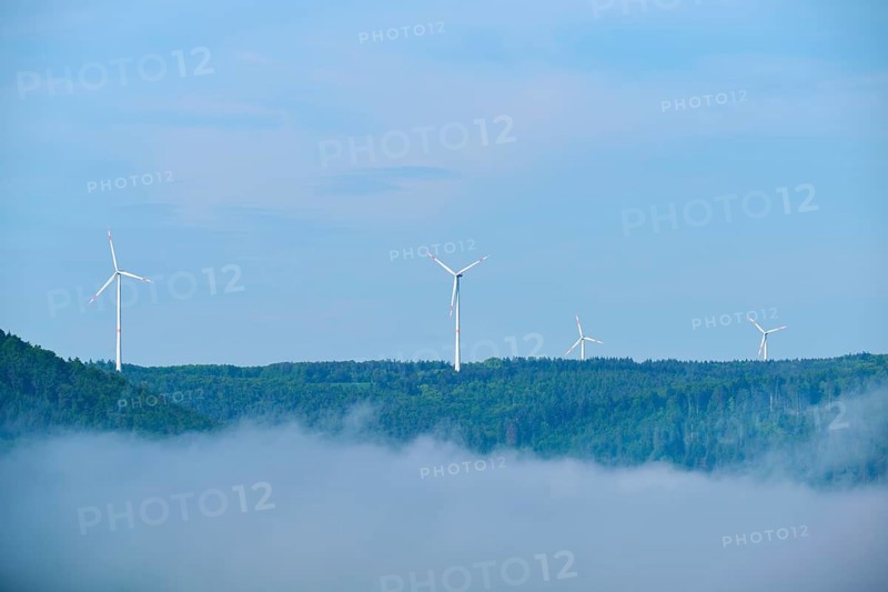 Wind turbines on a hill on a foggy morning