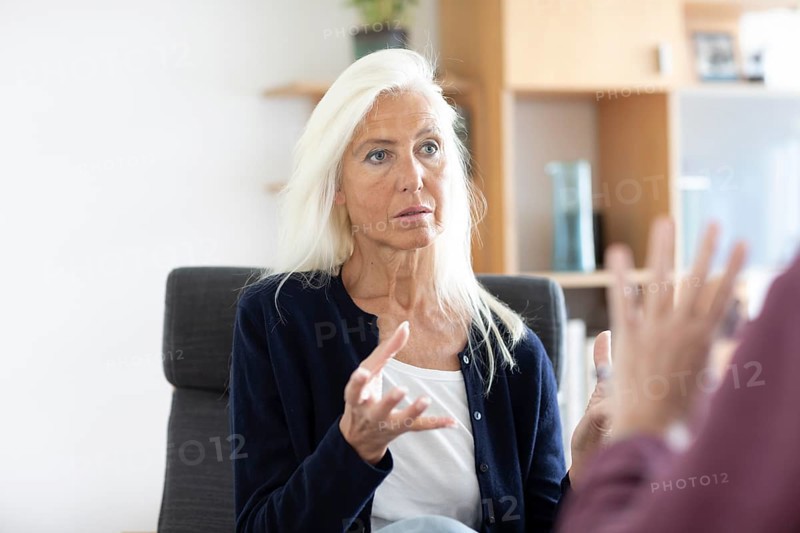 Therapist talking to a patient in a practice