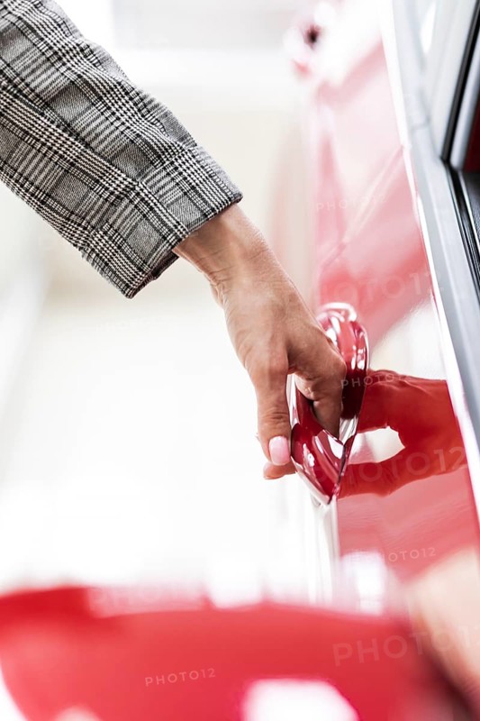 Businesswoman opening car door