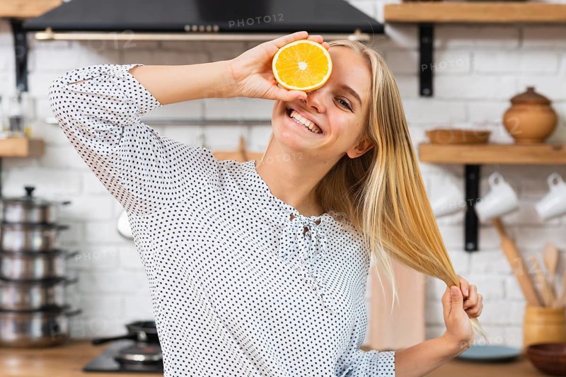 Medium shot smiley woman with half orange