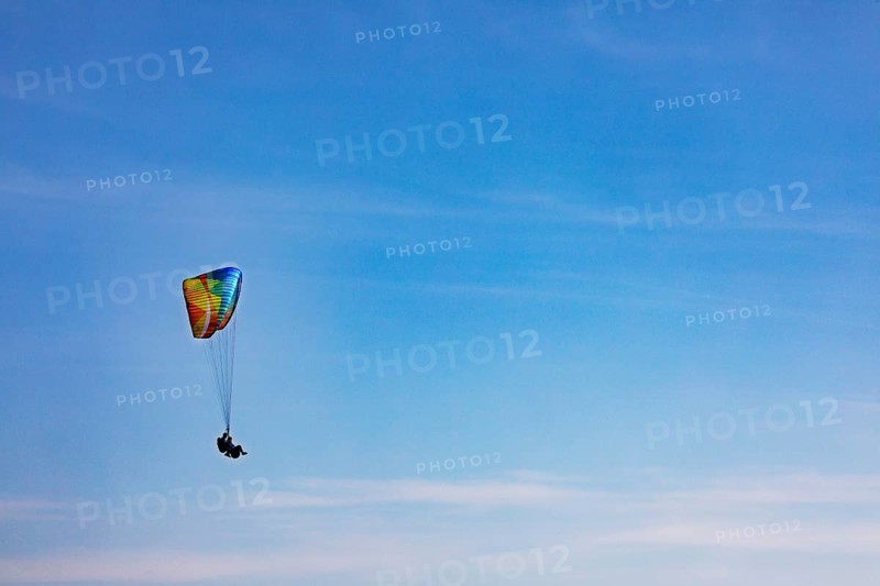 Tandem paragliding high in the sky
