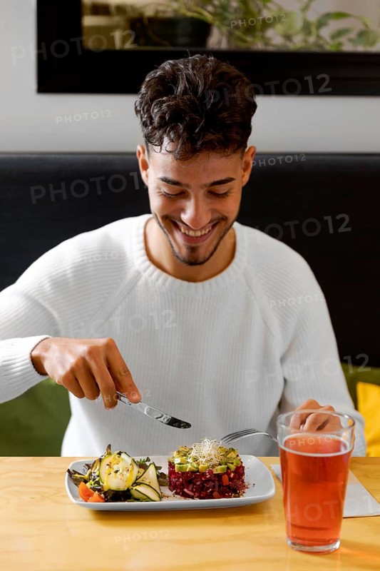 Medium shot man eating vegetarian food