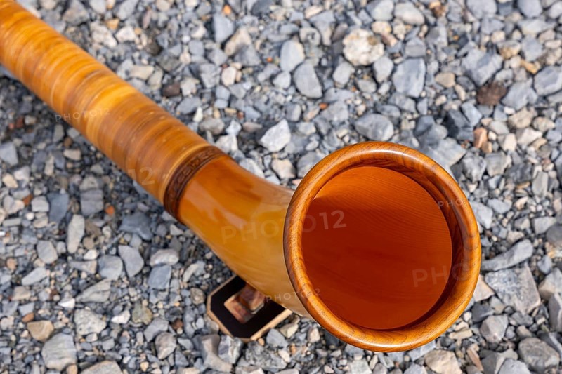 Music Instrument Alphorn Lying on the Ground in a Sunny Day in Switzerland