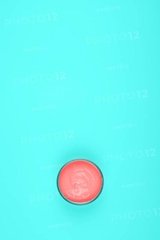 Overhead view coral paint turquoise green background