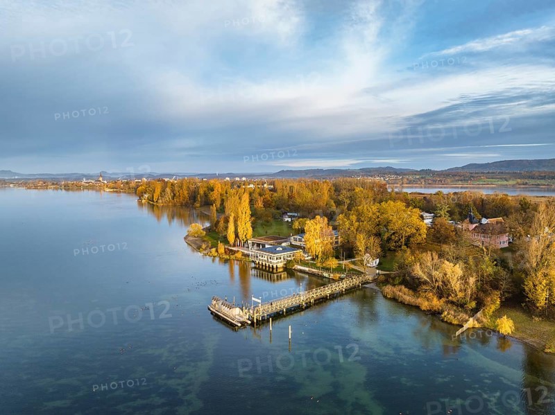 Aerial view of the Mettnau peninsula in western Lake Constance illuminated by the morning sun with the landing stage