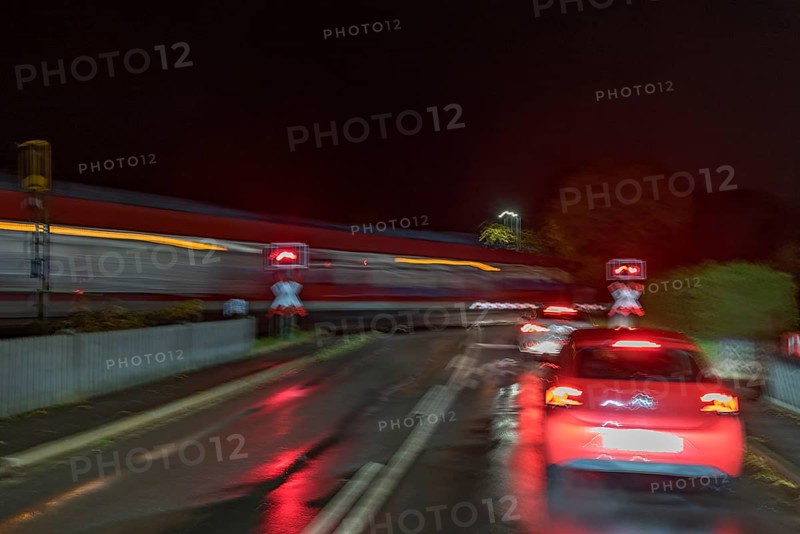 Train crossing a level crossing at night