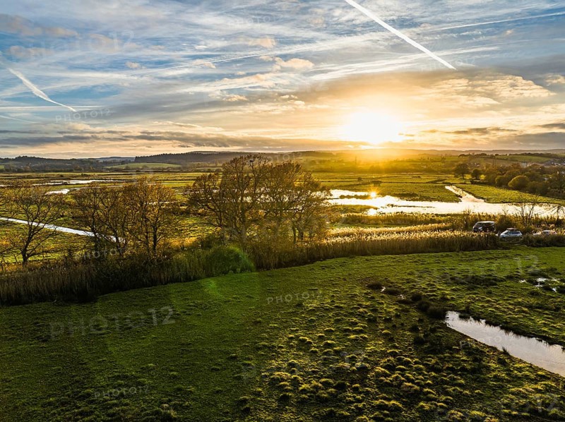 Sunset over Wetlands and Marshes in RSPB Exminster and Powderham Marshe from a drone