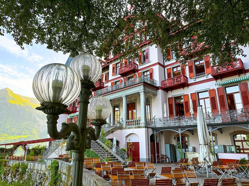 Grandhotel Giessbach with Terrace and Street Lamp in a Sunny Summer Day in Brienz