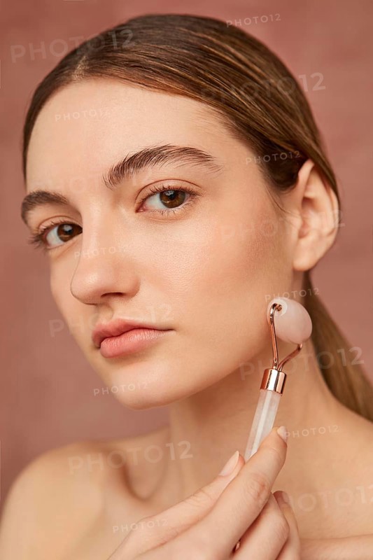 Close up woman posing with face tool