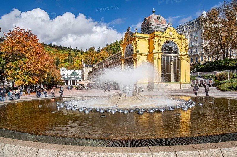 Spa colonnade with singing fountain in the autumnal spa park