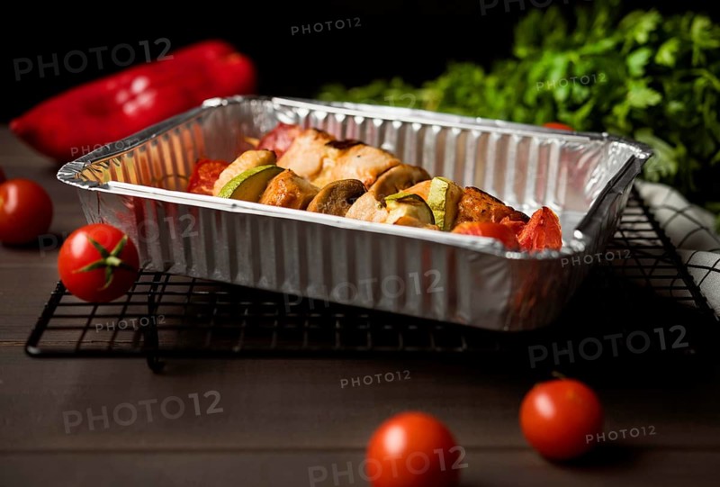 High angle chicken skewers tray with red pepper cherry tomatoes