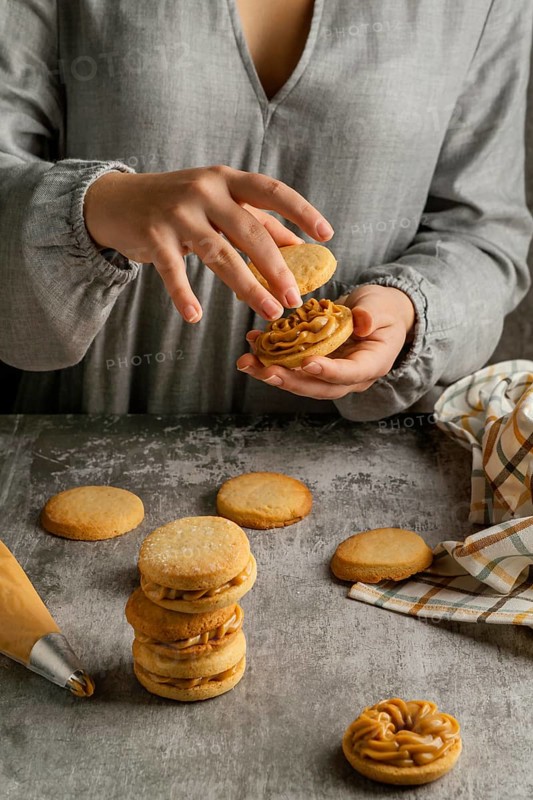 Close up hands preparing tasty alfajores