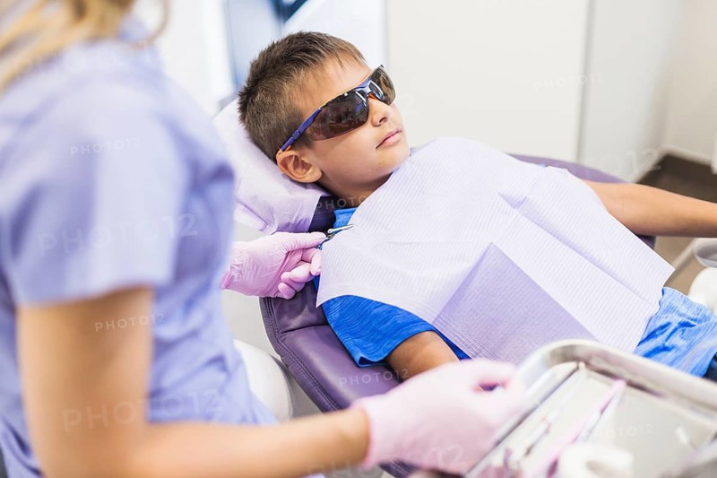 Female dentist examining teeth patient clinic