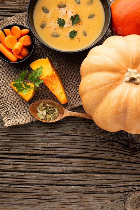 Flat lay pumpkin soup carrots pumpkin with copy space