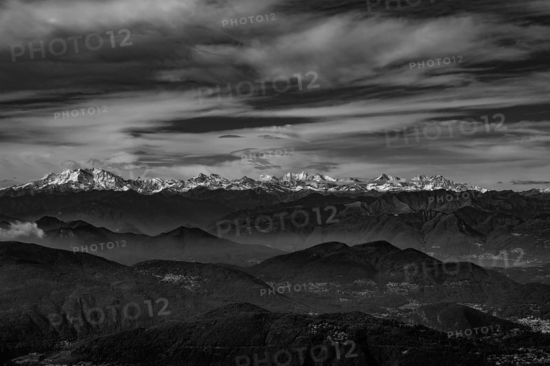 Aerial View over a Beautiful Mountainscape and And Snow Capped Monte Rosa and Mountain Peak Matterhorn and with Floating Clouds in a Sunny Day in Ticino