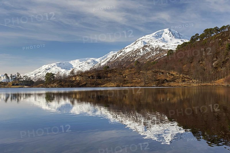 Caledonian Forest along Loch Affric and mountain Sgurr na Lapaich in winter