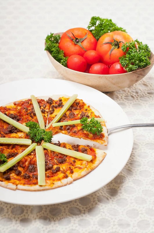 Fresh baked Turkish beef pizza with cucumber on top