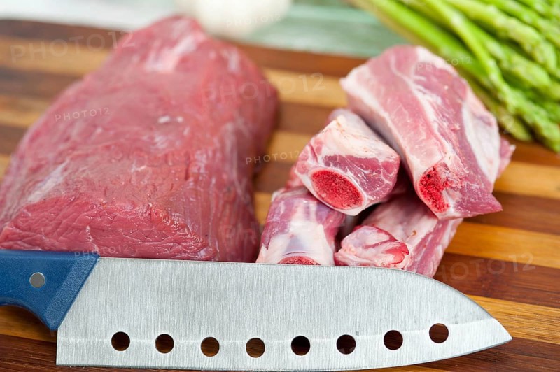 Raw beef and pork ribs with asparagus and herbs ready to cook