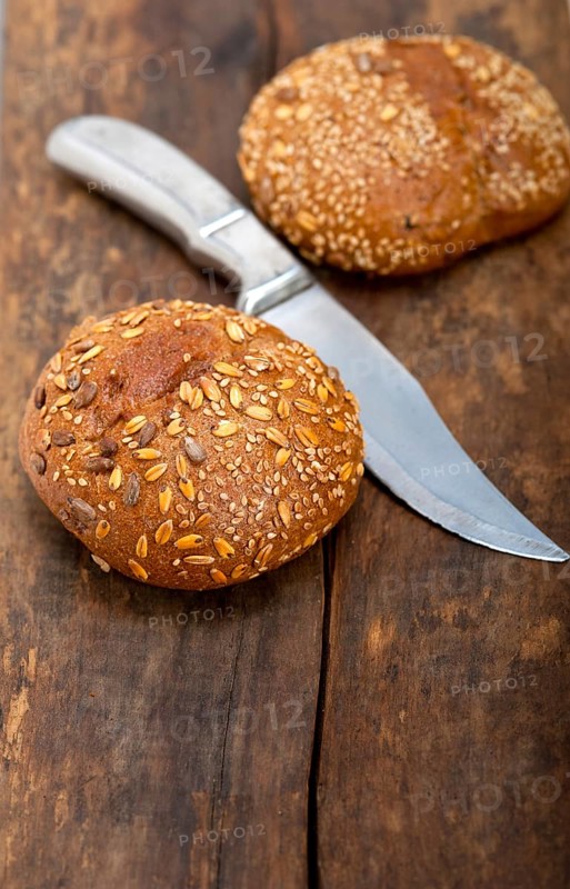 Fresh organic bread over rustic table macro closeup
