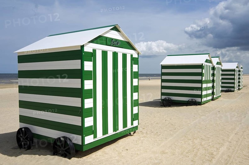 Row of colourful beach cabins on wheels along the North Sea coast at De Panne