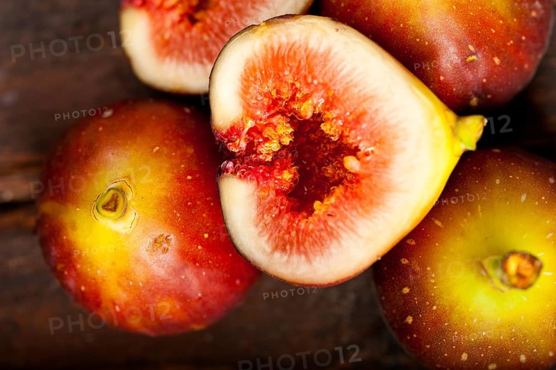 Fresh figs macro closeup over old wood boards