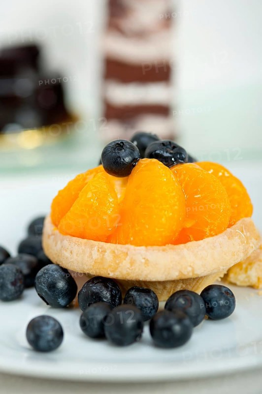 Fresh blueberry and tangerine orange cream cupcake homemade closeup macro