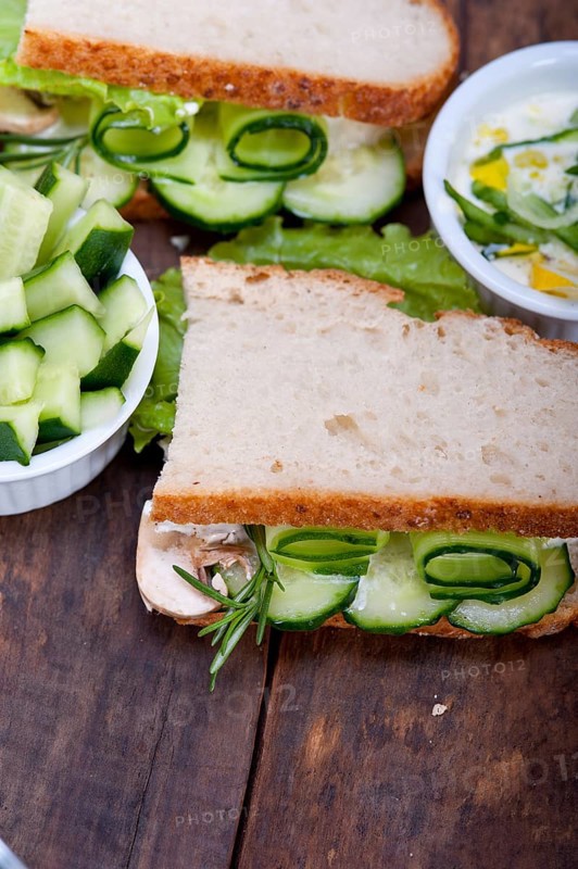 Fresh vegetarian sandwich with garlic cheese dip salad on rustic table
