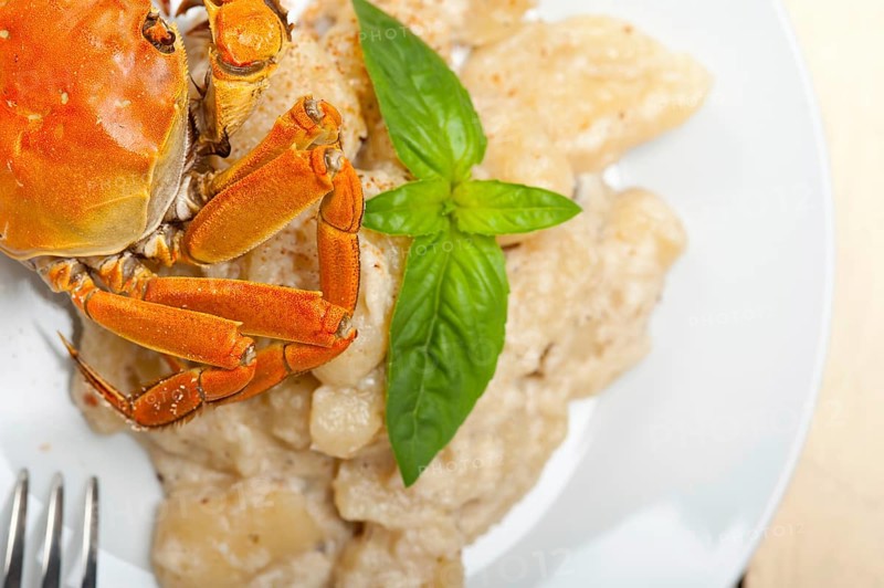 Fresh homemade Italian gnocchi with seafood sauce crab and basil