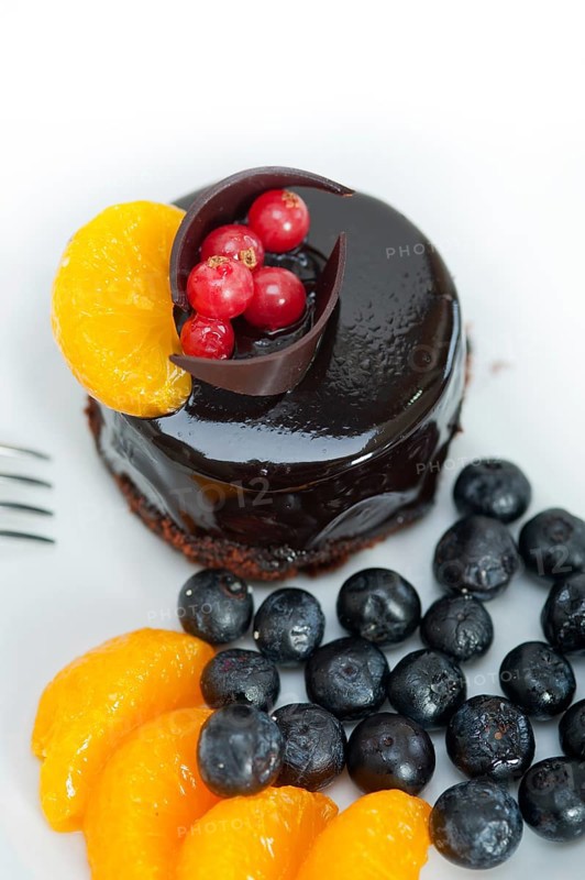 Chocolate cake and fresh fruit on top closeup macro