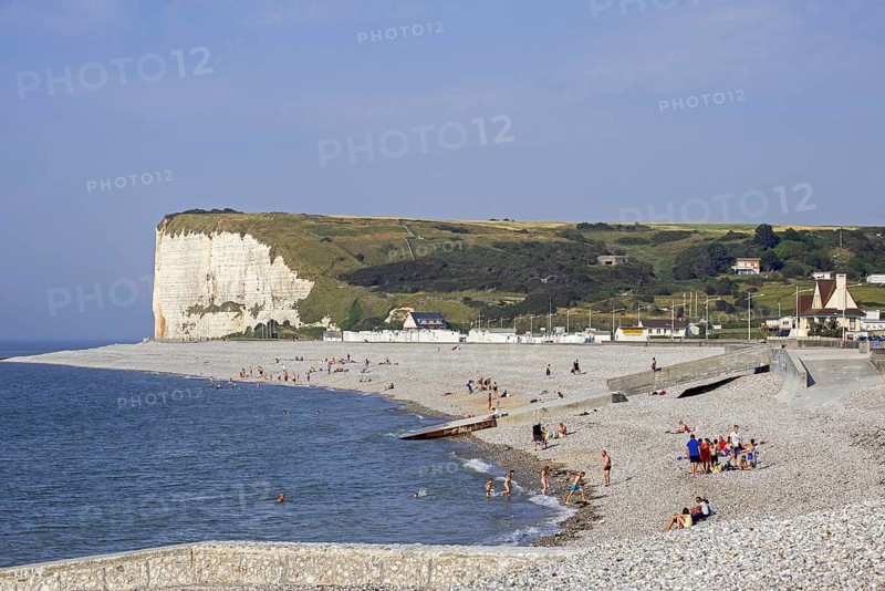 White chalk cliffs and sunbathers on pebble beach at Veulettes-sur-Mer