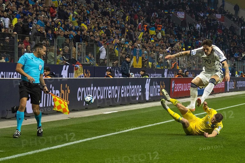 Vitaly MYKOLENKO Ukraine clears in front of Nicolo' ZANIOLO Italy in front of the linesman