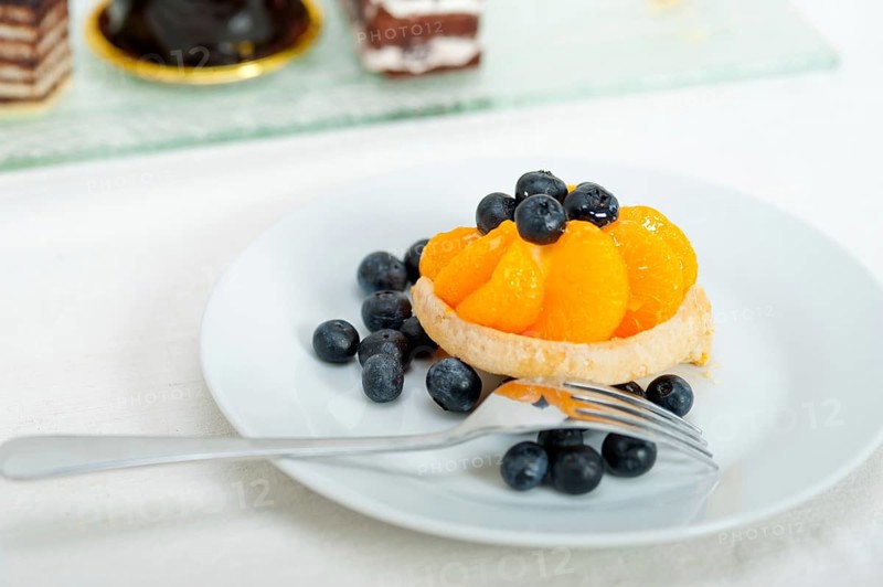 Fresh blueberry and tangerine orange cream cupcake homemade closeup macro