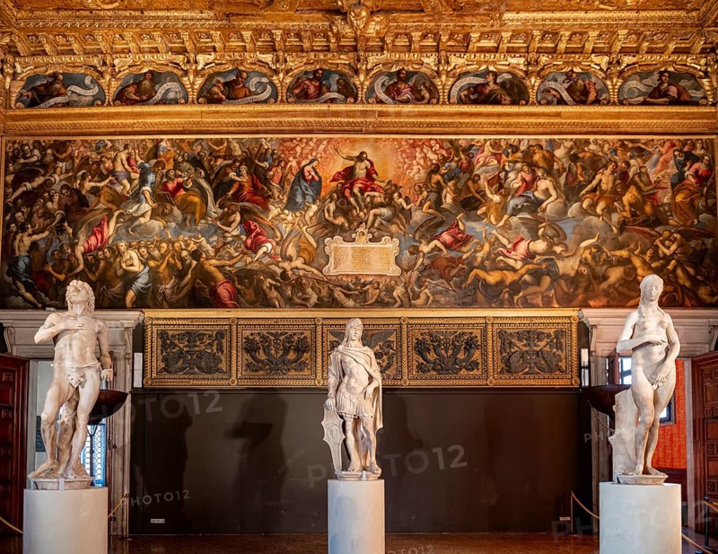 Sculptures in front of decorated wall