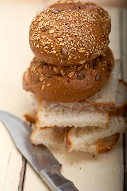 Fresh organic bread over rustic table macro closeup
