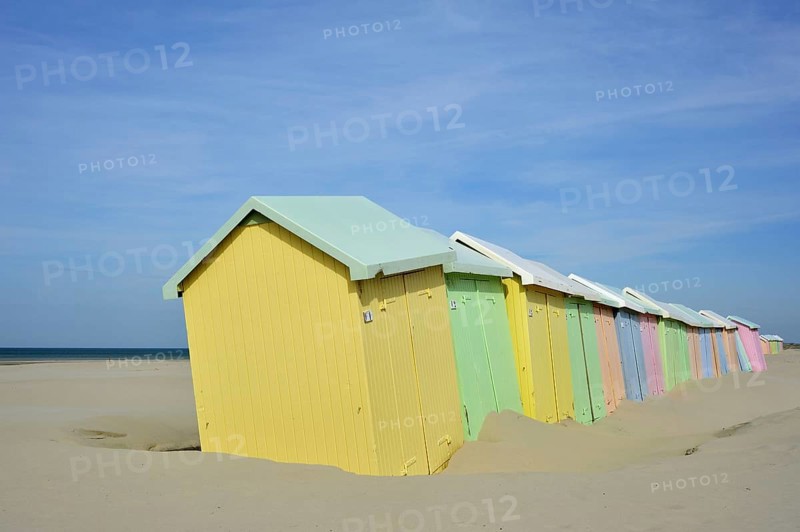 Row of colourful beach cabins in pastel colours along the North Sea at Berck