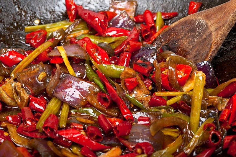Fried chili pepper and vegetable on a iron wok pan