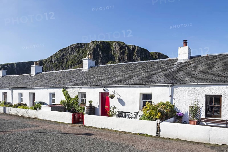 Row of white-harled workers cottages in former slate-mining village Ellenabeich on the isle of Seil